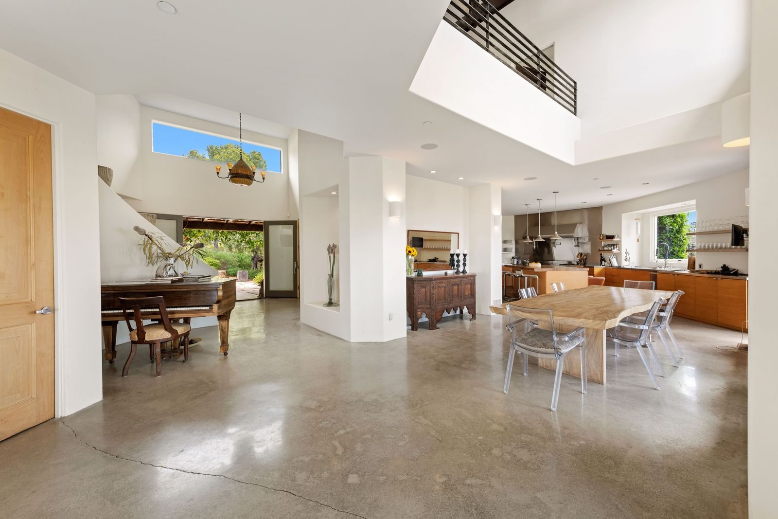 Polished concrete floor in a bright open-plan home with dining and kitchen areas, a popular finish for Phoenix-area homes